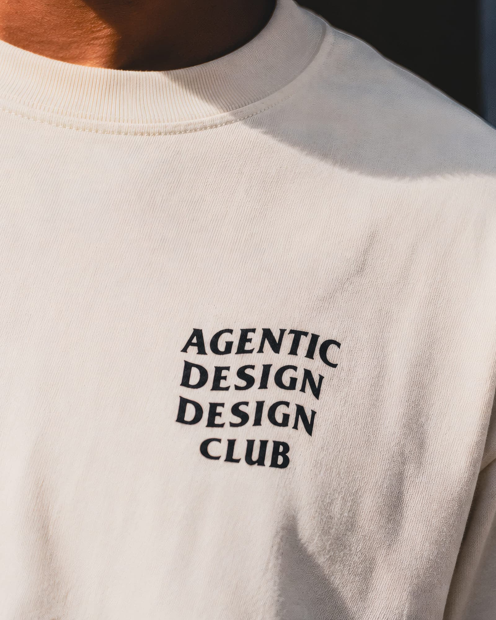 Close-up of the Agentic Design Design Club chest print